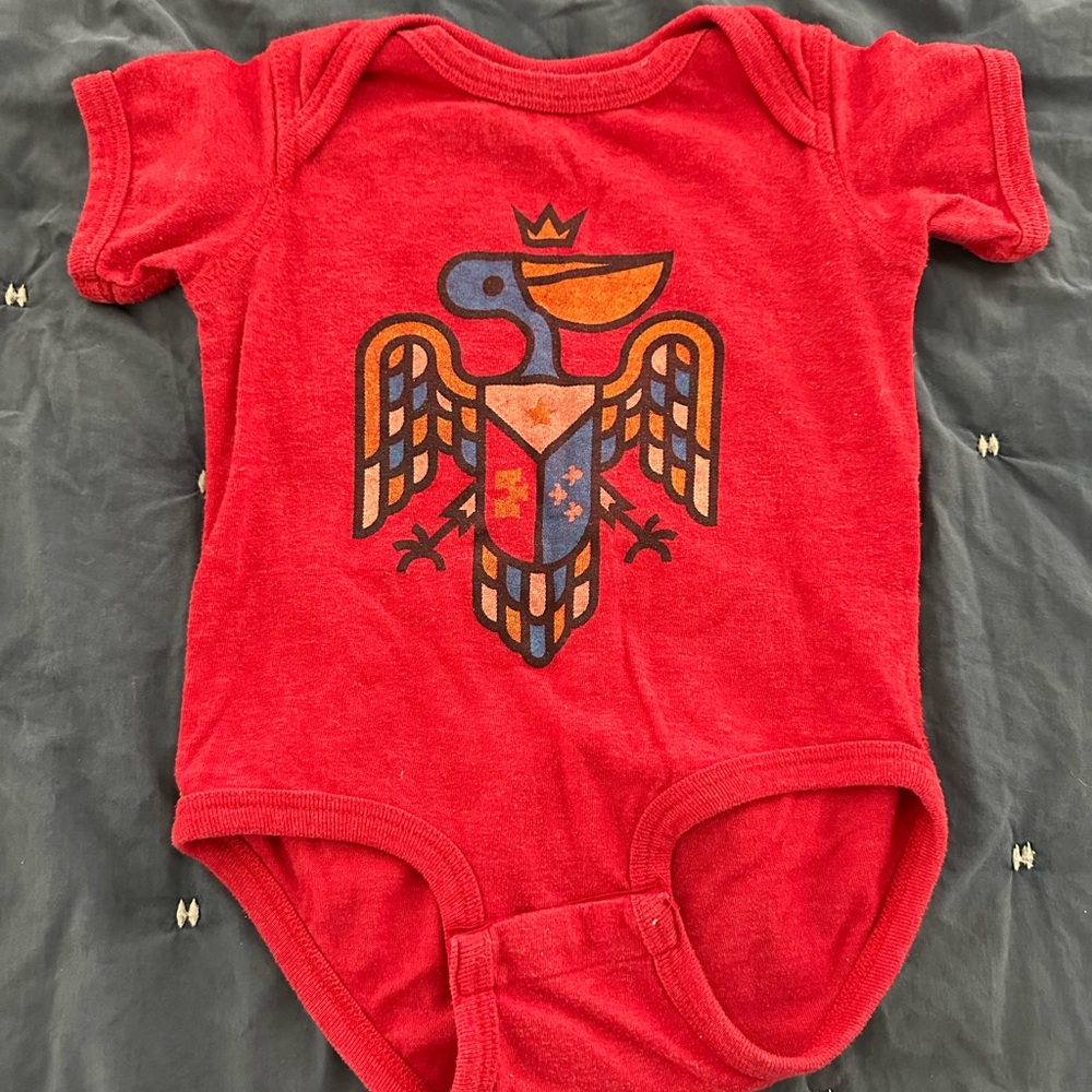 Acadian flag pelican onesie. Parish Ink